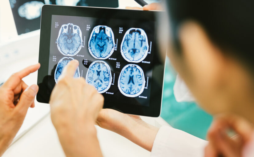 Doctor and patient using digital tablet in hospital