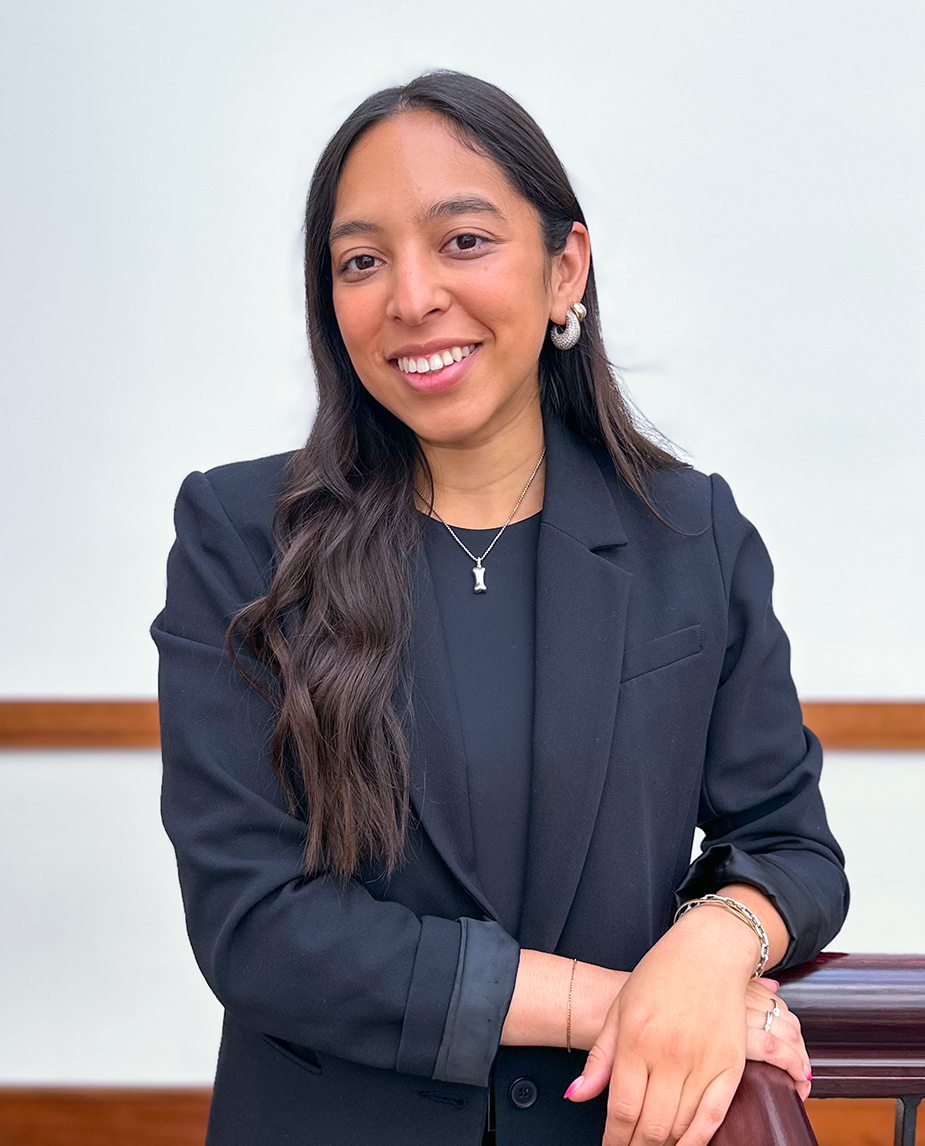 Professional headshot of Kimberly Padron - paralegal at the Law Offices of Dean Malone, P.C,a woman with curly brown hair and a light grey blazer